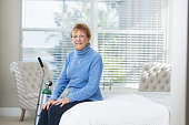 Senior woman at home with portable oxygen tank