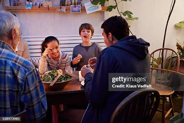 3 generations laughing together at meal - denmark people happy ストックフォトと画像