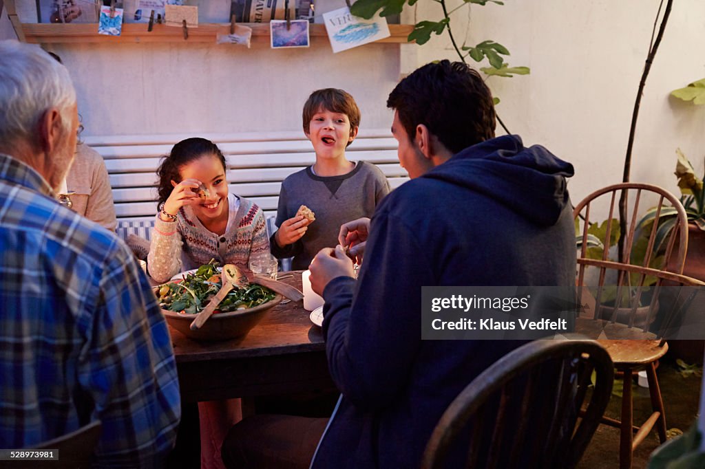 3 generations laughing together at meal