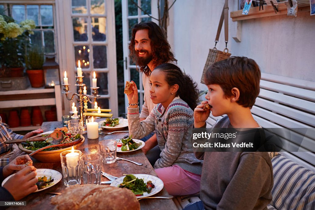 Family having dinner in greenhouse