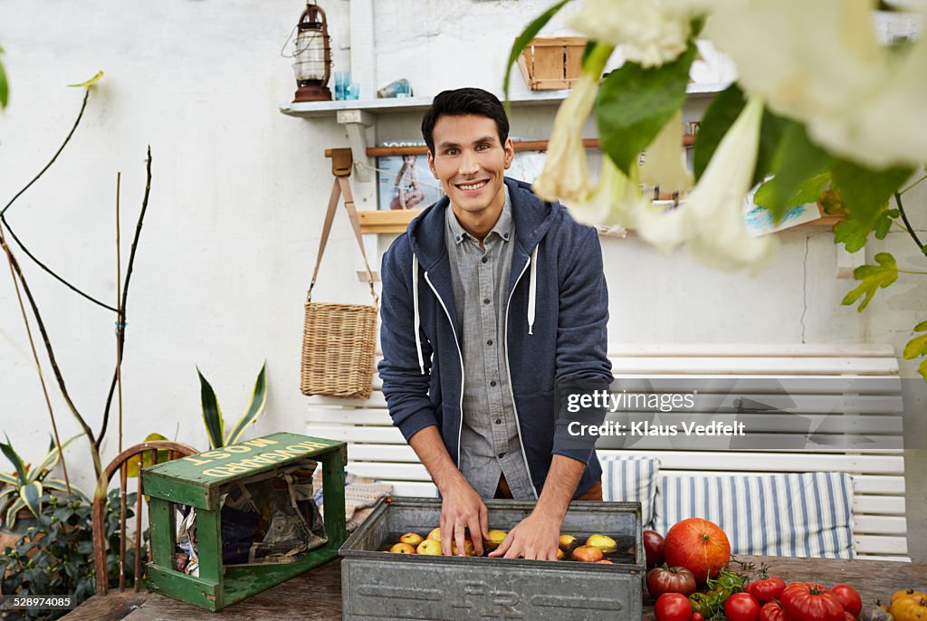 Portrait of man washing apples in a greenhouse