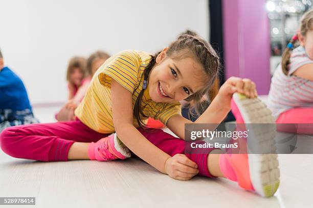 happy little girl doing stretching exercises in a health club. - gymnastics stretches stock pictures, royalty-free photos & images