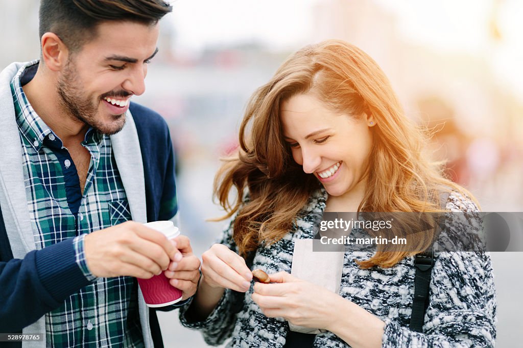 Young couple peeling chestnuts