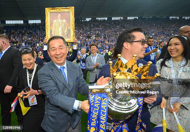 Leceister City owner Vichai Srivaddhanaprabha and son Aiyawatt Srivaddhanaprabha hold the Premier League Trophy after the Barclays Premier League...