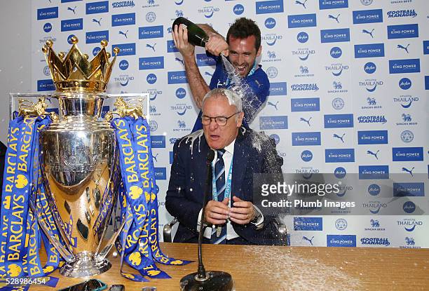 Leicester City's Christian Fuchs pours champagne over manager Claudio Ranieri during their team's press conference following their win over Everton...
