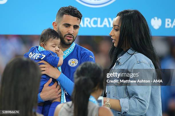 Riyad Mahrez of Leicester City holds daughter Inaya as wife Rita looks on, as Leicester City celebrate becoming Premier League Champions for the...