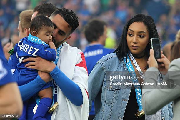 Riyad Mahrez of Leicester City holds daughter Inaya as wife Rita looks on, as Leicester City celebrate becoming Premier League Champions for the...