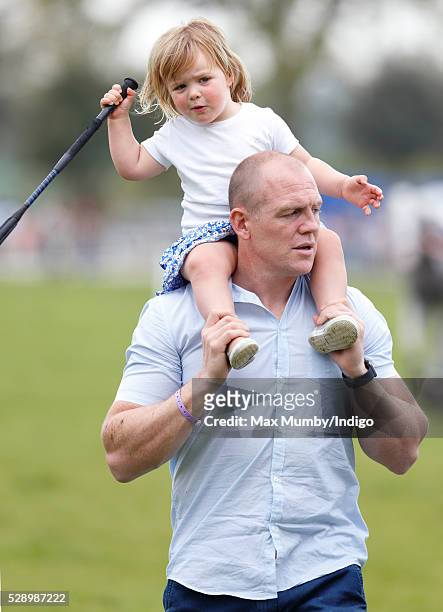 Mike Tindall carries daughter Mia Tindall on his shoulders after watching Zara Tindall compete in the cross country phase of the Badminton Horse...