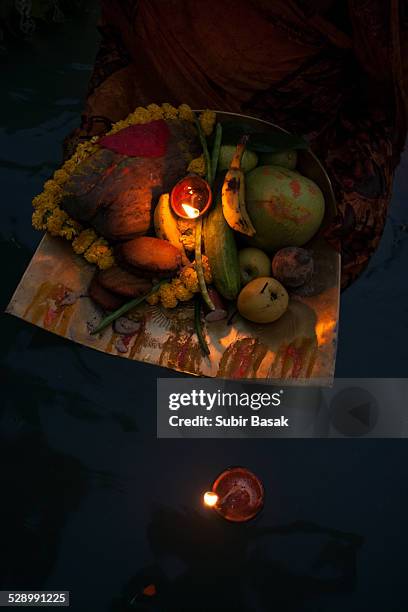 woman performing the ritual during chhat puja - chhath festival stock pictures, royalty-free photos & images