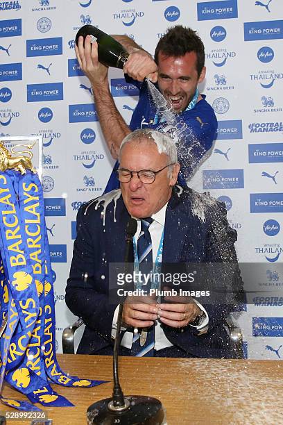 Leicester City's Christian Fuchs pours champagne over manager Claudio Ranieri during their team's press conference following their win over Everton...