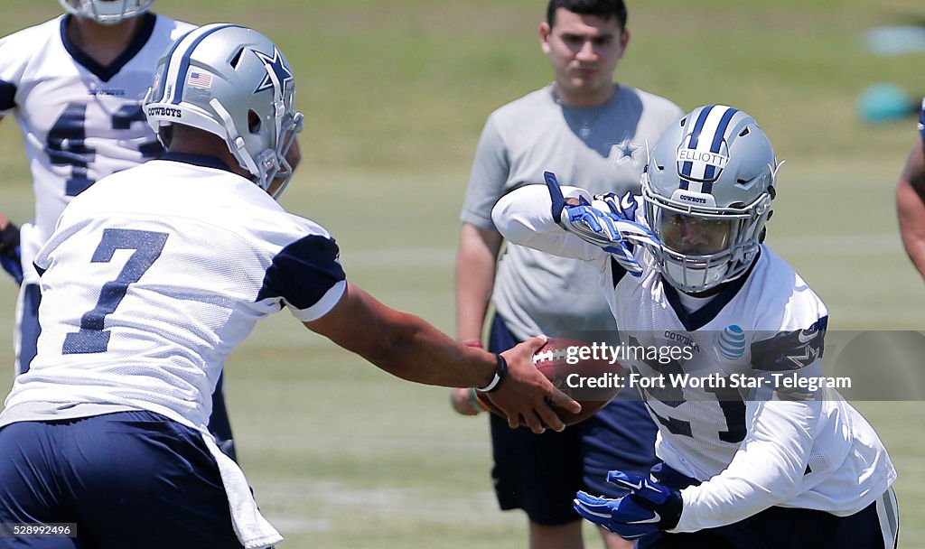 Dallas Cowboys quarterback Jameill Showers hands the ball off to Dallas Cowboys quarterback Jameill Showers hands the ball off to