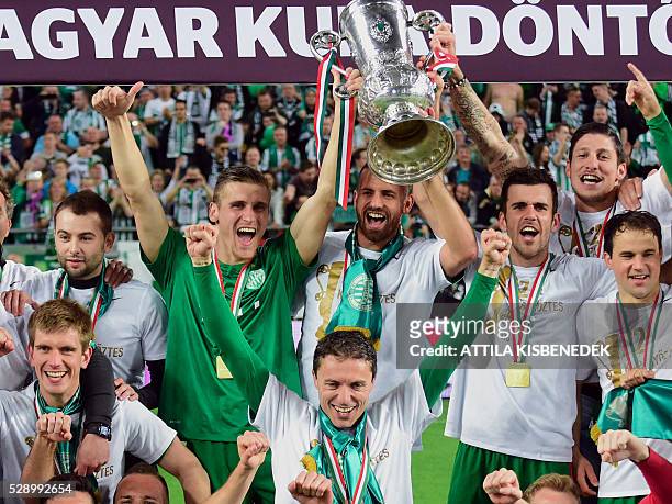 Players of TC Frerencvaros celebrate with the trophy after the Hungarian Cup final football match against FC Ujpest at the Groupama Arena in Budapest...