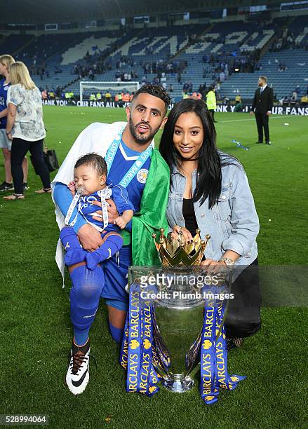 Riyad Mahrez of Leicester City and partner Rita Johal celebrate with the Premier League trophy after the Barclays Premier League match between...