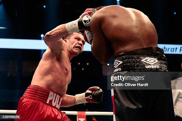 Kubrat Pulev of Bulgaria throws a punch at Dereck Chisora of Great Britain during Heavyweight European Championship between Kubrat Pulev and Dereck...