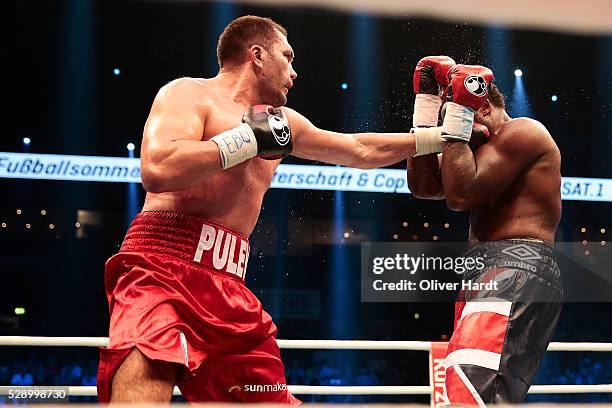 Kubrat Pulev of Bulgaria throws a punch at Dereck Chisora of Great Britain during Heavyweight European Championship between Kubrat Pulev and Dereck...