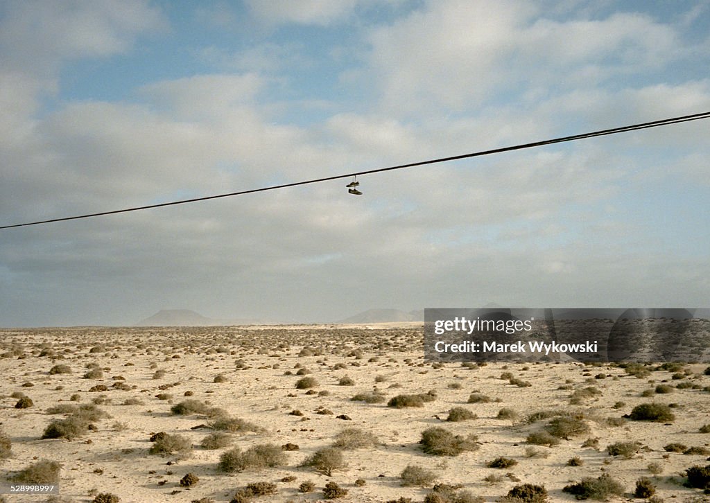 Shoes hanging over a desert