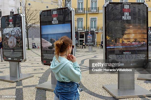 Woman watches ‘Aqu�� Morreu Uma Mulher' , a display of photographs and texts denouncing femicide, in Camoes square, Lisbon, Portugal, 16 March 2016....