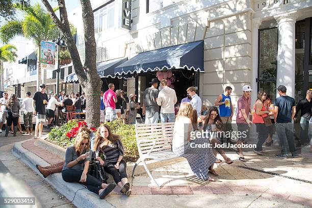 large group of young adults gather in west palm beach - west palm beach stock pictures, royalty-free photos & images