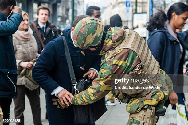 Brussels 23 March 2016.Soldiers check everyone who wants to use the subway, at underground entrance De Brouckere in the center of Brussels. This guy...