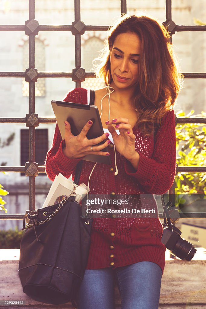 Tourist Woman Reading Newspaper On Tablet