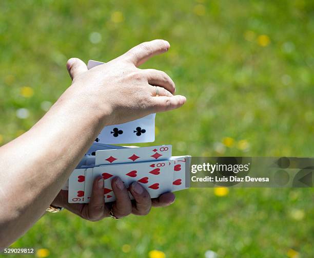 shuffling cards, close-up of hands - volles haus stock-fotos und bilder