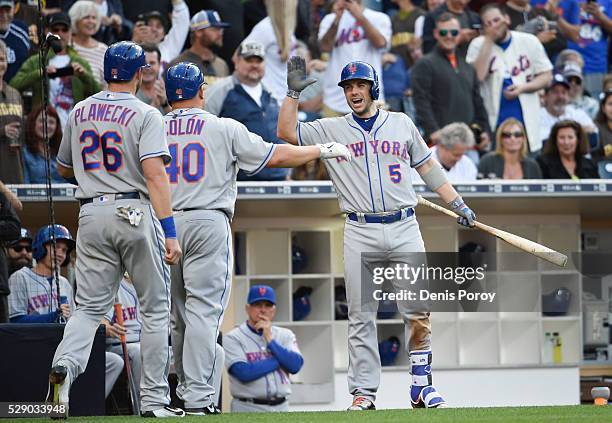 Bartolo Colon of the New York Mets, center, is congratulated by David Wright as Kevin Plawecki looks on after Colon hit a two-run home run for the...