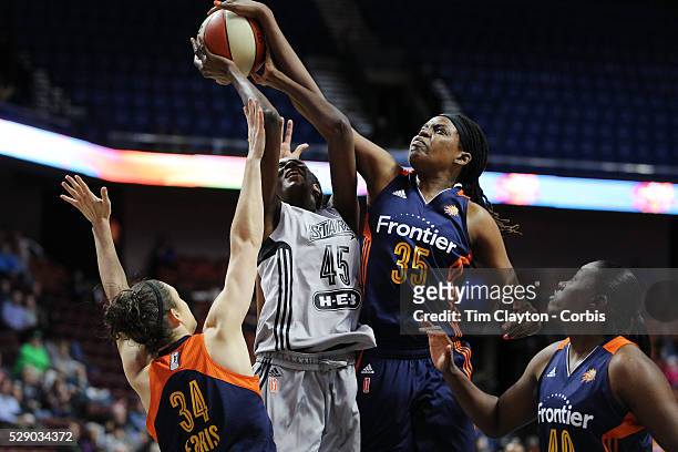 Astou Ndour, , of the San Antonio Stars is fouled as she drives to the basket by Kelly Faris of the Connecticut Sun as Jonquel Jones of the...