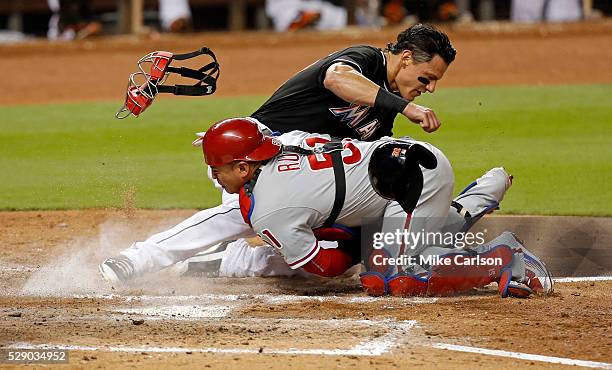 Derek Dietrich of the Miami Marlins is tagged out at home by Carlos Ruiz of the Philadelphia Phillies during the fifth inning of a game at Marlins...