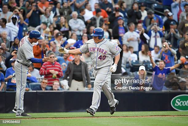 Bartolo Colon of the New York Mets, right, is congratulated by Tim Teufel after hitting a two-home run home run for the first of his career during...