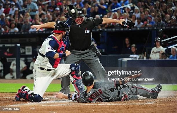 Wellington Castillo of the Arizona Diamondbacks scores a sixth inning run against A. J. Pierzynski of the Atlanta Braves at Turner Field on May 7,...