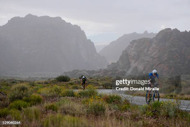 Triathletes bike uphill during the St. George Ironman 70.3 North American Pro Championships on May 7, 2016 in St. George, Utah.