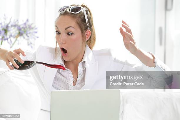 woman dressed in white spilling glass of wine . - wine stain imagens e fotografias de stock