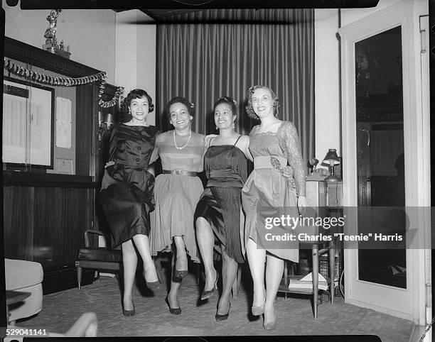 Group portrait of members of Girl Friends Inc., Marion Bond Jordon, Hazel Garland, Mrs. Woody Harris, and Adah Lavelle, posed in Press Club for...