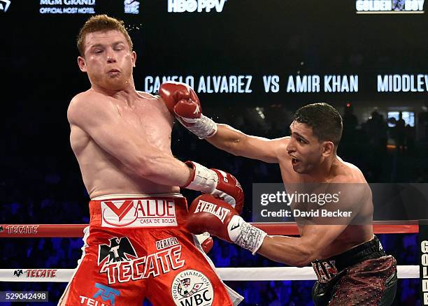Amir Khan throws a right at Canelo Alvarez during a WBC middleweight title fight at T-Mobile Arena on May 7, 2016 in Las Vegas, Nevada. Alvarez won...