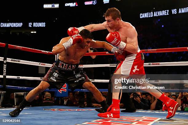 Canelo Alvarez throws a right at Amir Khan during the WBC middleweight title fight at T-Mobile Arena on May 7, 2016 in Las Vegas, Nevada.