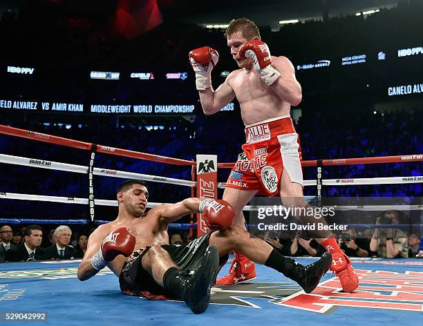 Canelo Alvarez stands over Amir Khan after delivering a knockout punch during the sixth round of their WBC middleweight title fight at T-Mobile Arena...