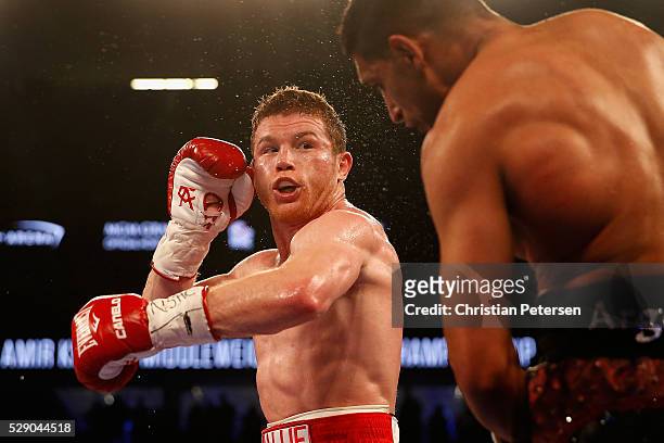 Canelo Alvarez throws a left at Amir Khan during the WBC middleweight title fight at T-Mobile Arena on May 7, 2016 in Las Vegas, Nevada.