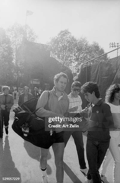 John McEnroe signing autographs at a tennis match; circa 1970; New York