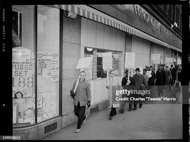 Men, including minister of Trinity Lutheran Church Roy S. Lahet second from left, and women, picketing outside Woolworth's protesting discrimination...