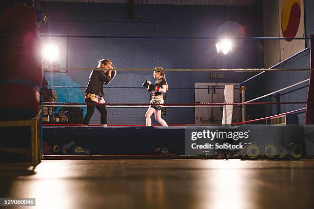 teaching her to fight! - boxing ring stock pictures, royalty-free photos & images