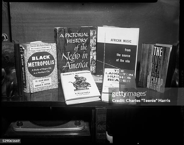 Six books displayed on shelf, including titles 'Black Metropolis,' 'A Pictorial History of the Negro in America,' 'Booker T. Washington a Biography,'...