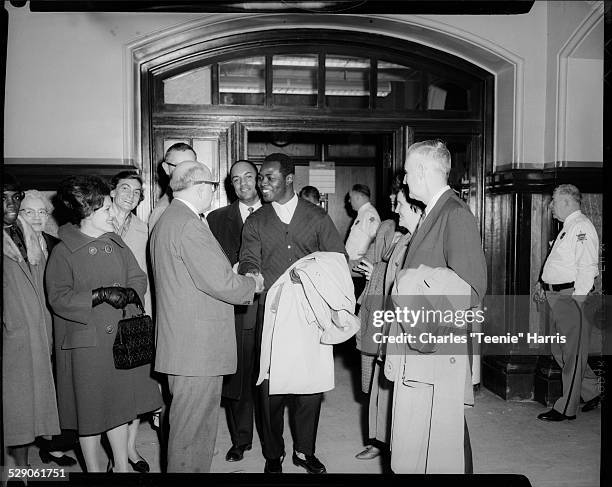 Atty. Samuel Goldstock congratulating Zacheus Okediji after acquittal, with, from left: Nadine Ratterman wearing dark gloves, Florence Shute, Dr....