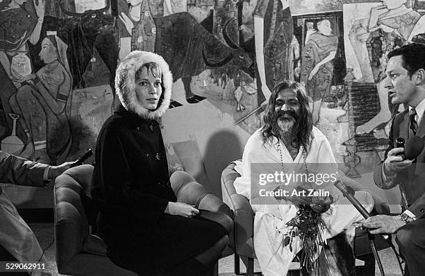 Actress Mia Farrow and Maharishi Mahesh Yogi before boarding plane at Kennedy Airport for New Delhi; circa 1960; New York.