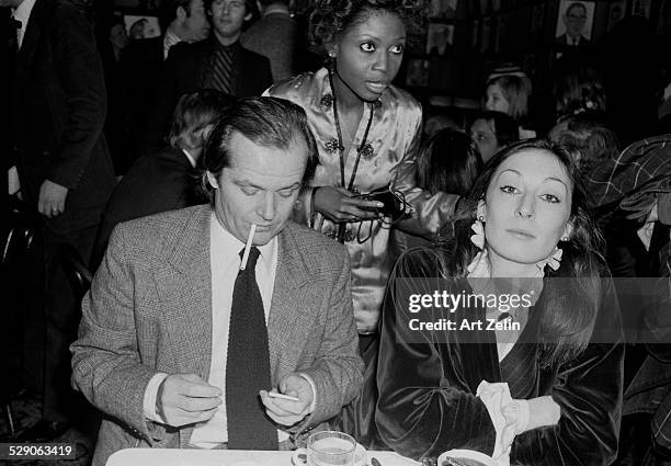 Anjelica Huston seated with Jack Nicholson at Sardis; circa 1960; New York.