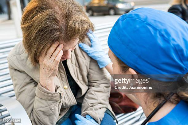 female doctor assisting a senior woman - stroke stock pictures, royalty-free photos & images