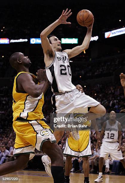 Manu Ginobili of the San Antonio Spurs shoots past Jerome James of the Seattle SuperSonics in Game five of the Western Conference Semifinals during...