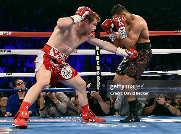 Canelo Alvarez battles with Amir Khan during a WBC middleweight title fight at T-Mobile Arena on May 7, 2016 in Las Vegas, Nevada. Alvarez won by a...