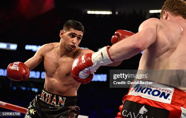 Amir Khan and Canelo Alvarez battle during a WBC middleweight title fight at T-Mobile Arena on May 7, 2016 in Las Vegas, Nevada. Alvarez won by a...