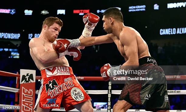 Canelo Alvarez battles with Amir Khan during a WBC middleweight title fight at T-Mobile Arena on May 7, 2016 in Las Vegas, Nevada. Alvarez won by a...