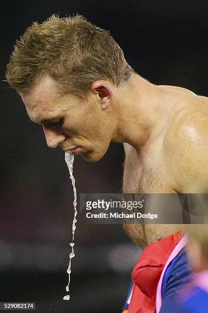 Drew Petrie of the Kangaroos spits out fluid at at three quarter time during the round seven AFL match between the St Kilda Saints and the North...